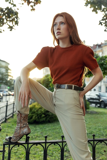 Beautiful redhead woman posing on the street