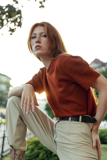 Beautiful redhead woman posing on the street