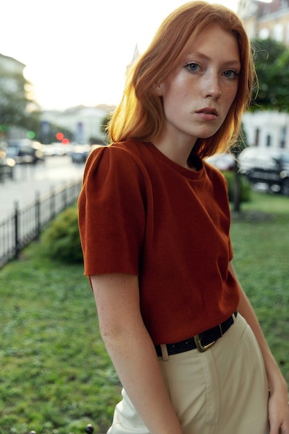 Beautiful redhead woman posing on the street