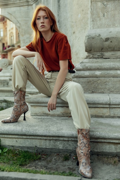 Beautiful redhead woman posing on the street