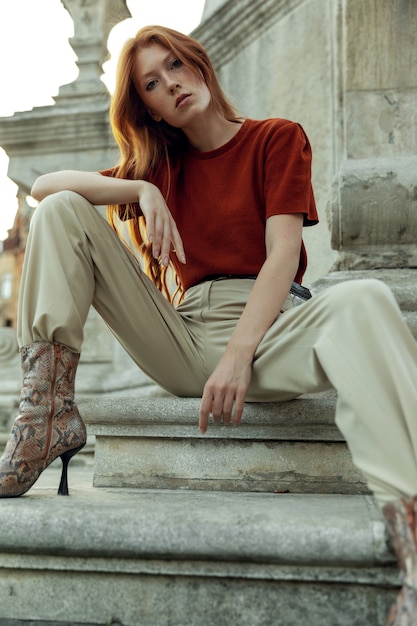 Beautiful redhead woman posing on the street