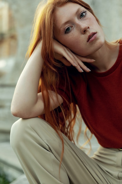 Beautiful redhead woman posing on the street