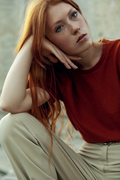 Beautiful redhead woman posing on the street