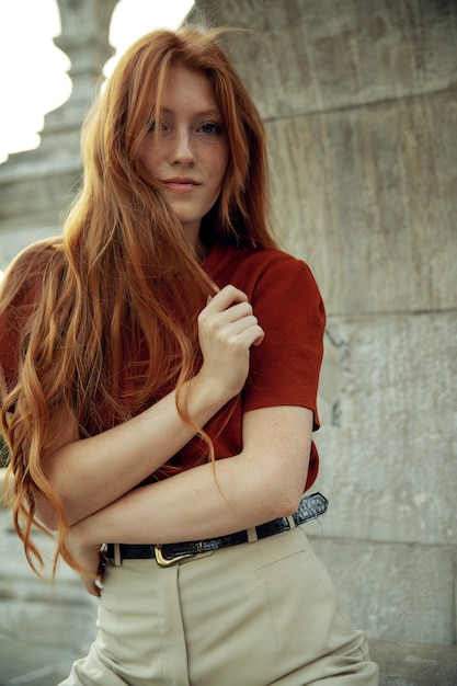 Beautiful redhead woman posing on the street