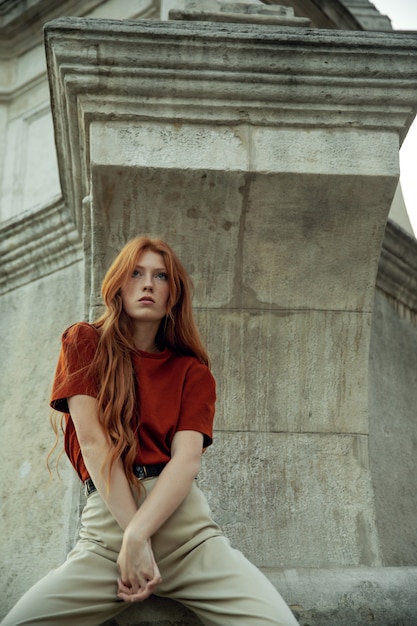 Beautiful redhead woman posing on the street