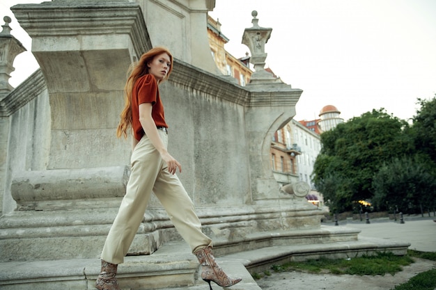 Beautiful redhead woman posing on the street