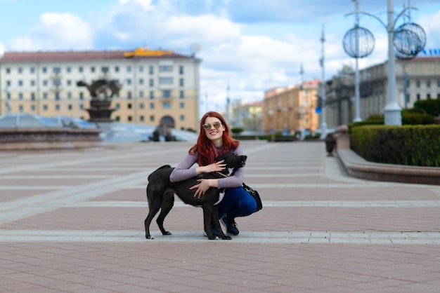 Beautiful redhead woman walking her dog