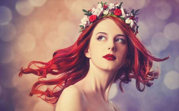 Beautiful redhead women with wreath.