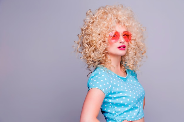 Beautiful retro-style blonde girl with voluminous curly hairstyle