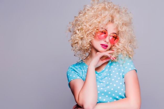 Beautiful retro-style blonde girl with voluminous curly hairstyle