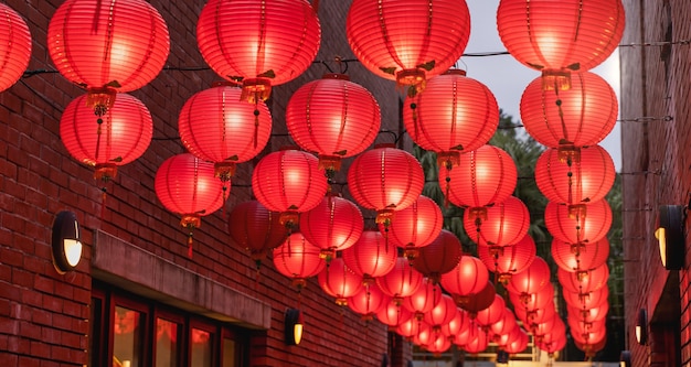 Beautiful round red lantern hanging on old traditional street, concept of Chinese lunar new year festival, close up. The undering word means blessing.