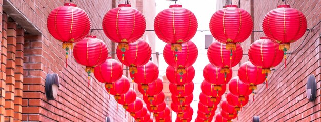 Beautiful round red lantern hanging on old traditional street, concept of Chinese lunar new year festival, close up..