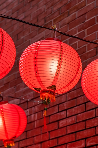 Beautiful round red lantern hanging on old traditional street, concept of Chinese lunar new year festival, close up..