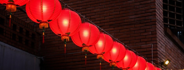 Beautiful round red lantern hanging on old traditional street concept of Chinese lunar new year festival in Taiwan close up The undering word means blessing