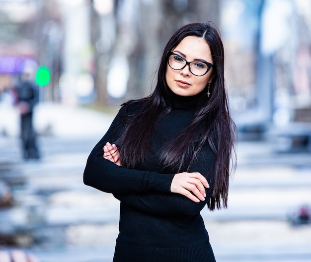 Beautiful russian girl dressed in black leather clothes and eyeglasses