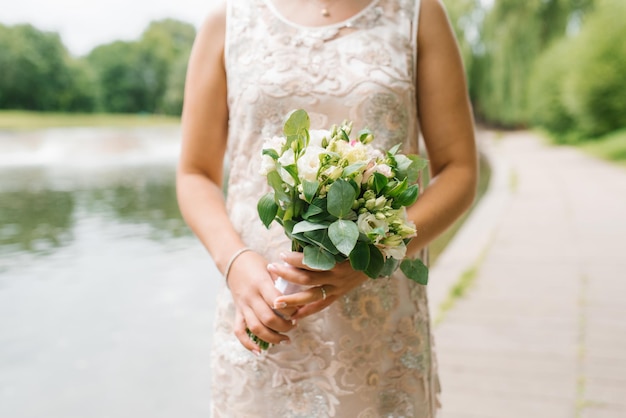 Beautiful rustic wedding bouquet in the hands of the bride