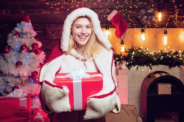 Beautiful santa woman blonde santa woman with christmas gift