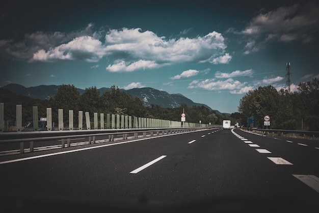 Beautiful scenic landscape on mountains covered with forests View from the car window on a modern and highquality highway