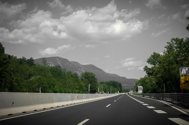 Beautiful scenic landscape on mountains covered with forests View from the car window on a modern and highquality highway