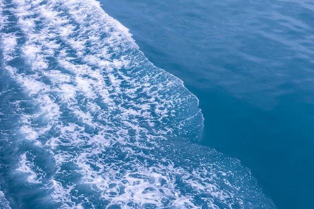 Beautiful sea waves with a lot of foam and bubbles on surface