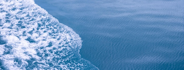 Beautiful sea waves with a lot of foam and bubbles on surface