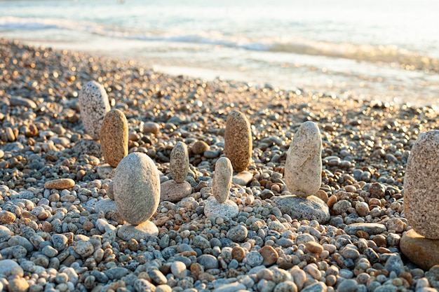 Beautiful seascape, amazing view of pebble coastline in mild sunset light, romantic evening on the beach.