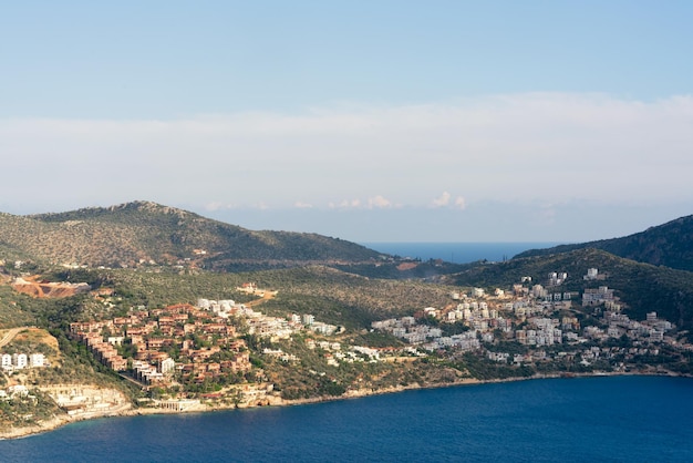 Beautiful seascape houses with red roofs on the rocky shore by the sea