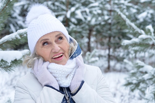 Beautiful senior woman posing outdoors in winter