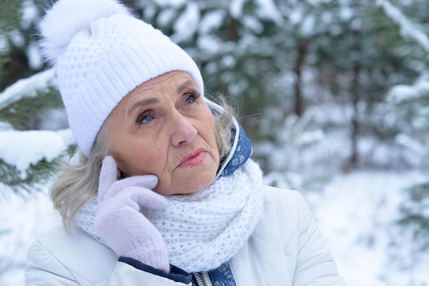 Beautiful senior woman posing outdoors in winter