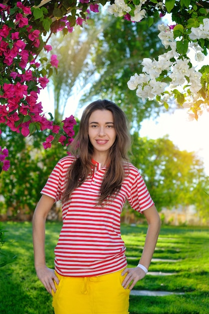 Beautiful sensuality young girl on a background of flowers