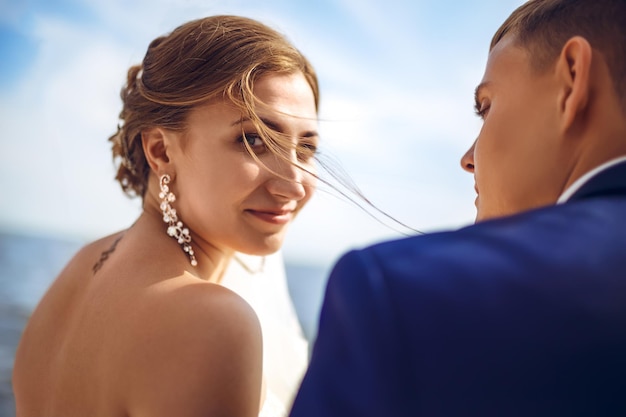 Beautiful sexy bride in white dress weeps tears of happiness on the wedding day