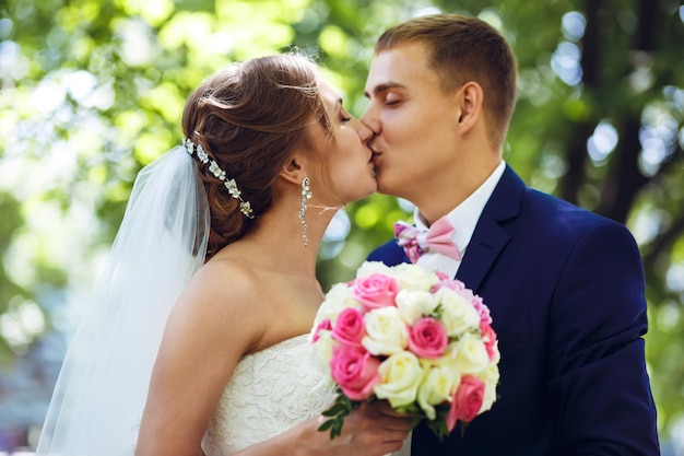 Beautiful sexy bride in white dress weeps tears of happiness on the wedding day