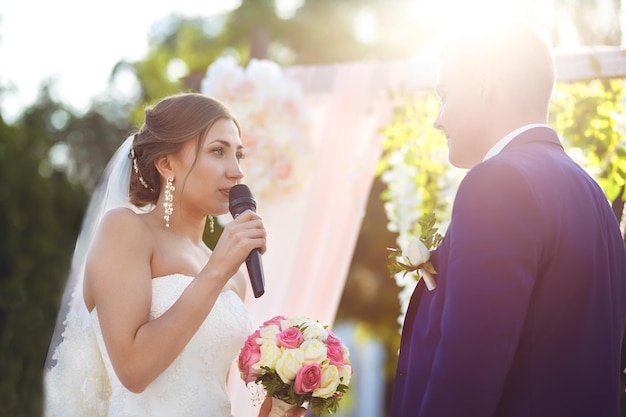 Beautiful sexy bride in white dress weeps tears of happiness on the wedding day