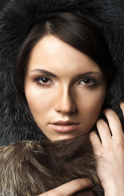 Beautiful sexy young brunette woman with fur