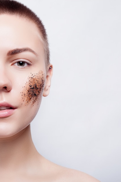 Beautiful short-haired woman with coffee scrub on her cheek