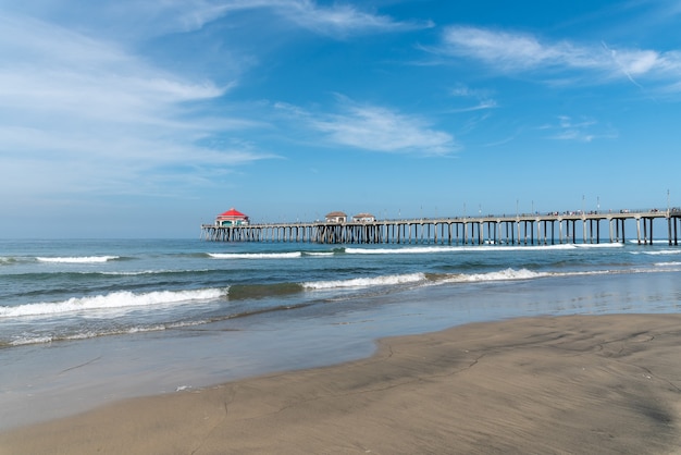 Beautiful shot of a calm empty beach with small houses on the dock