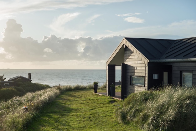 Beautiful shot of a holiday house in front of the sea on a thin clouds background