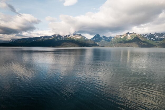 Beautiful shot of mountains surrounded by a calm lake in Alaska