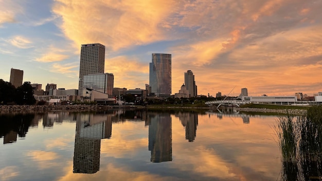 Beautiful shot of a reflection of buildings and sunset on the lak