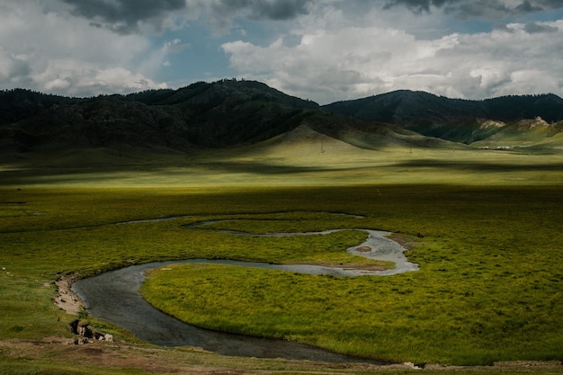 A beautiful Siberian landscape with a river against a background of mountains in the Altai Republic