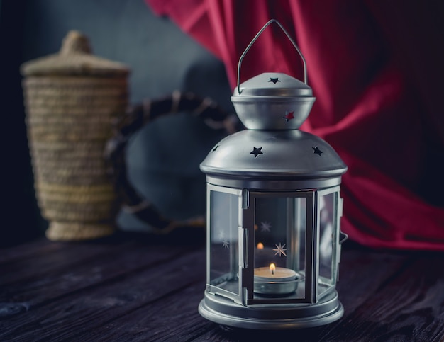 Beautiful silver candlestick on an old wooden table.