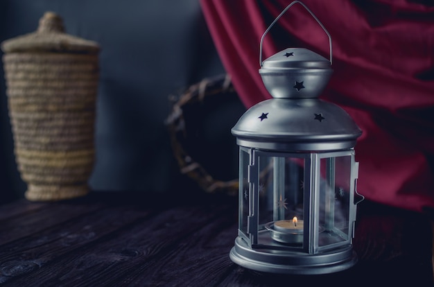 Beautiful silver candlestick on an old wooden table.