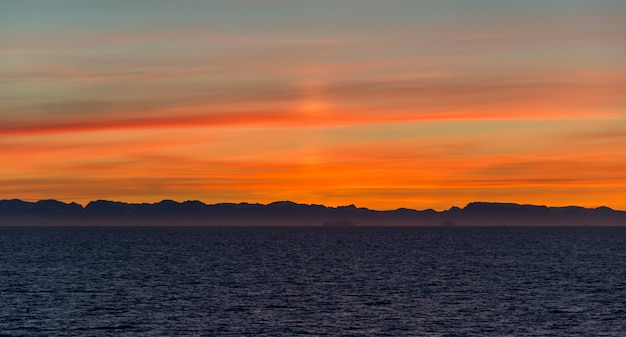 Beautiful sinrise in Greenland. Iceberg at sea.