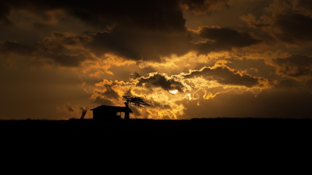 Beautiful Sky at Sunset with Cottage Silhouette