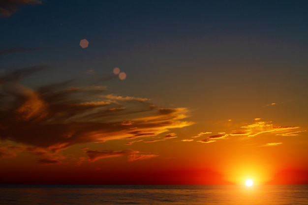 Beautiful sky with clouds at sunset over the sea