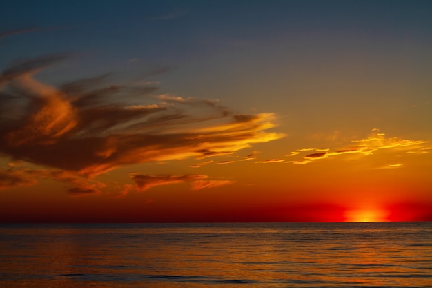 Beautiful sky with clouds at sunset over the sea