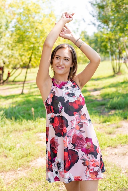 beautiful slender girl walking in a summer park