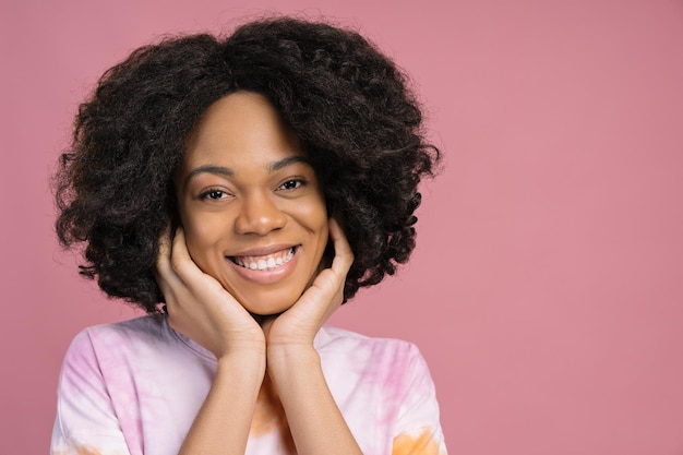 Beautiful smiling African American woman touching his face looking at camera Natural beauty