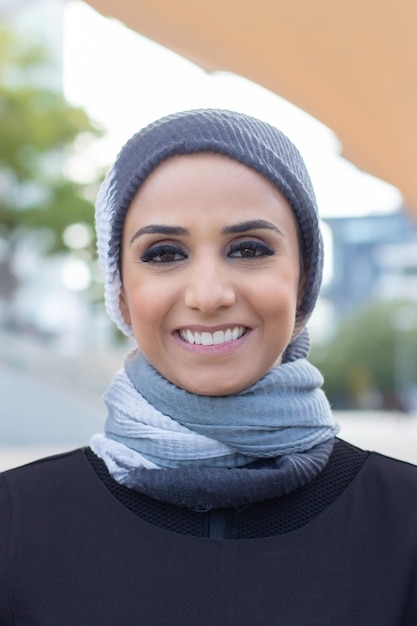 Beautiful smiling Arabic woman. Portrait of woman with covered head and make up looking at camera with bright smile. International, beautiful concept