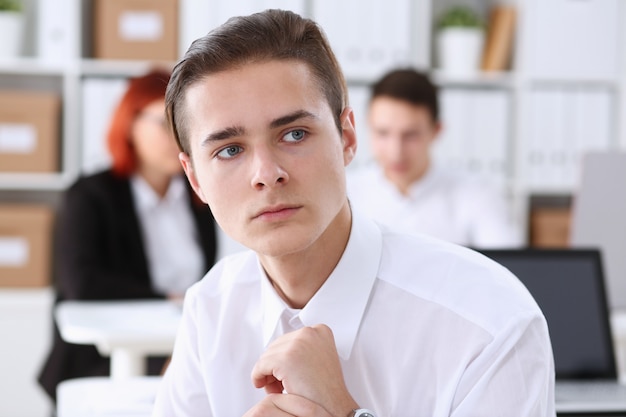 Beautiful smiling business man at workplace